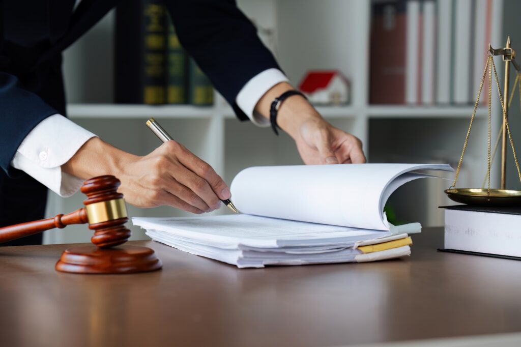 Close up lawyer hands holding pen, signing in white paper form or application to confirm and deal