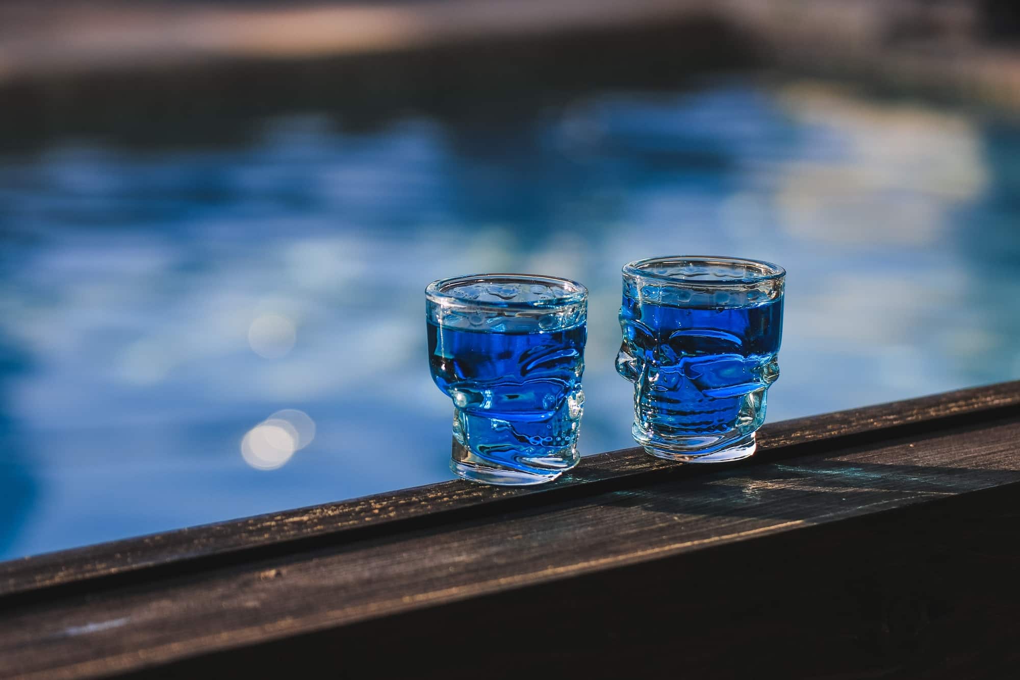 Two small glasses of blue alcohol